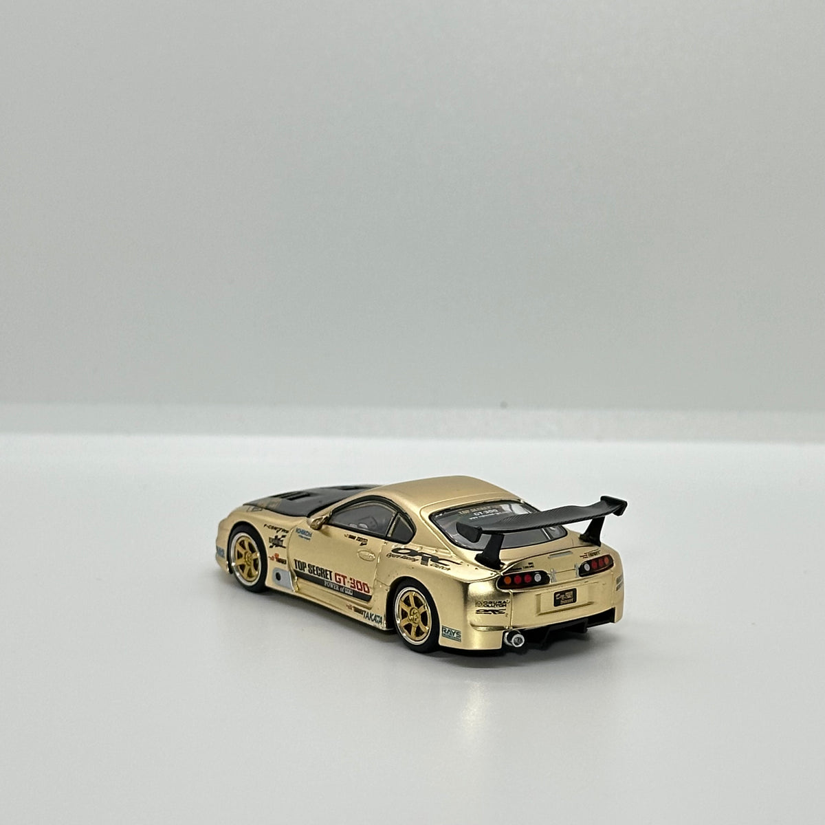 POP RACE PR64-277 Top Secret GT300 Supra gold 1:64 diecast rear three-quarter view